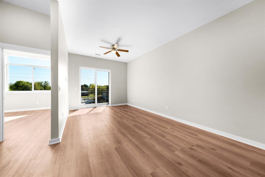 3522 Main Street, Unit 303 Rowlett, TX 75088 - Photo 8 of 23 Unfurnished room with light wood-style floors and ceiling fan