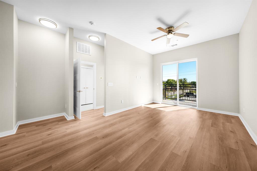 3522 Main Street, Unit 303 Rowlett, TX 75088 - Photo 9 of 23 Empty room with light wood-type flooring and ceiling fan
