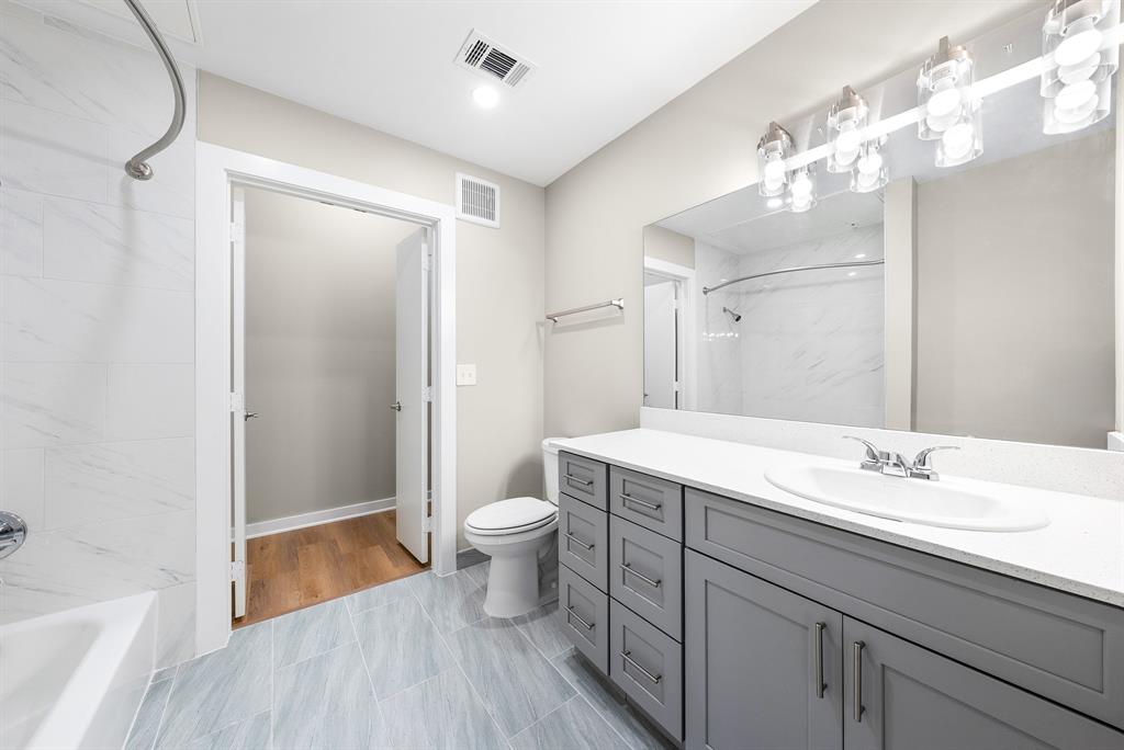 3522 Main Street, Unit 303 Rowlett, TX 75088 - Photo 14 of 23 Full bathroom featuring vanity and a combined bath / shower with marble appearance