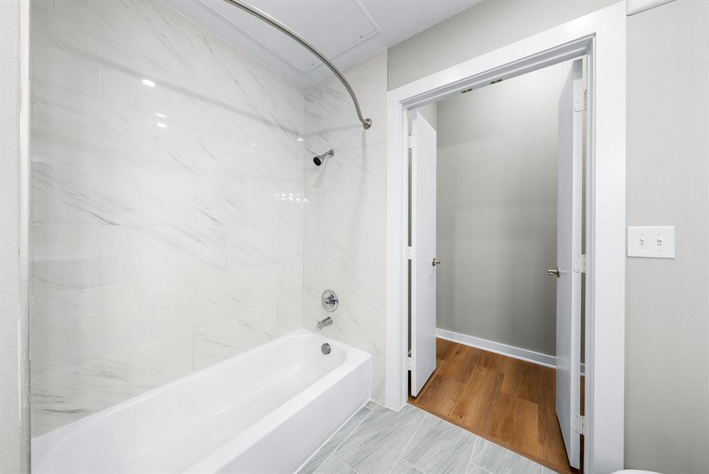 3522 Main Street, Unit 303 Rowlett, TX 75088 - Photo 15 of 23 Full bath featuring bathtub / shower combination and light wood-style floors