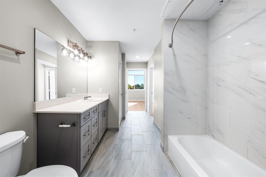 3522 Main Street, Unit 303 Rowlett, TX 75088 - Photo 16 of 23 Full bathroom featuring bathtub / shower combination and vanity