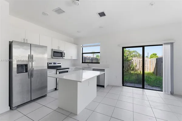a kitchen with appliances cabinets and a sink