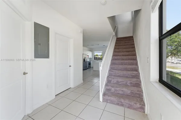a view of entryway and hall with wooden floor