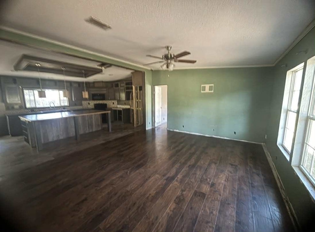39 County Road 2801 Cleveland, TX 77327 - Photo 2 of 10 an empty room with wooden floor and windows