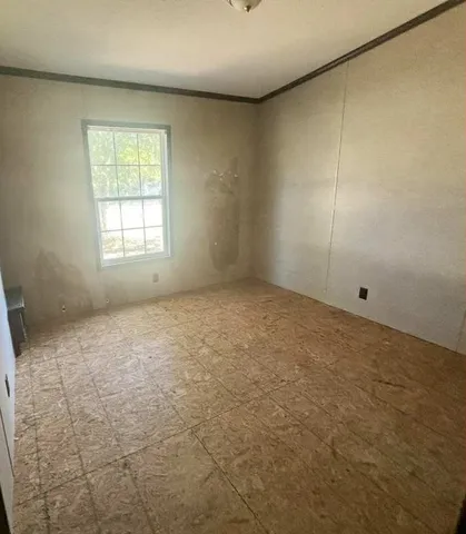 an empty room with a empty space and windows