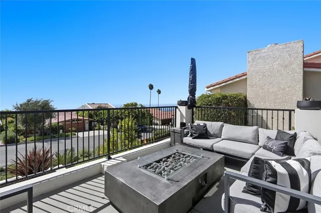 a view of kitchen with stainless steel appliances granite countertop a sink and a wooden floor