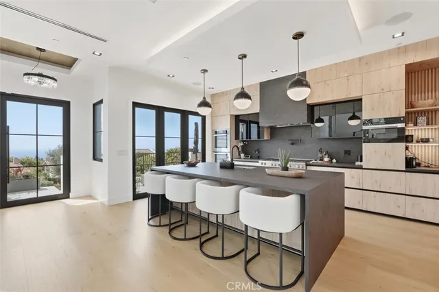 a kitchen with stainless steel appliances granite countertop a sink a stove and a refrigerator