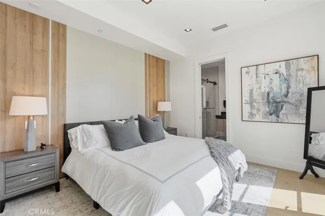 a bedroom with a large bed and a balcony