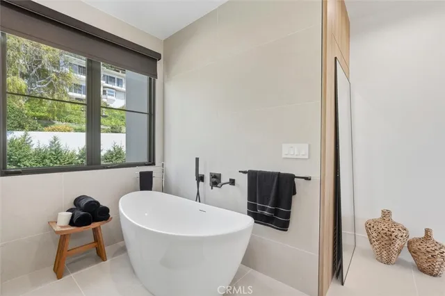 a bathroom with a glass shower door and a window