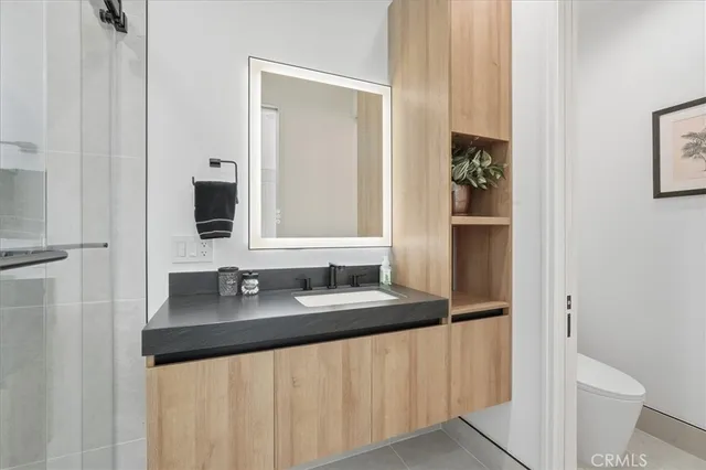 a bathroom with a granite countertop sink and a mirror