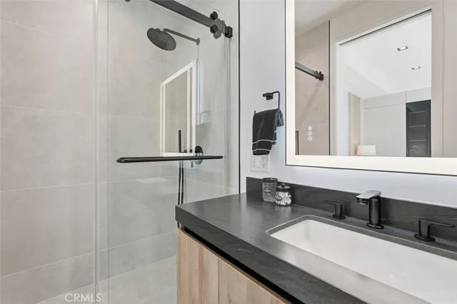 a bathroom with a sink mirror and vanity