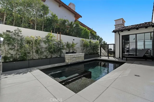 a view of a patio with couches table and chairs and potted plants