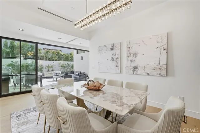 a view of a dining room with furniture large windows and wooden floor