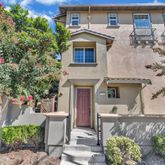 an aerial view of a house with a yard and potted plants