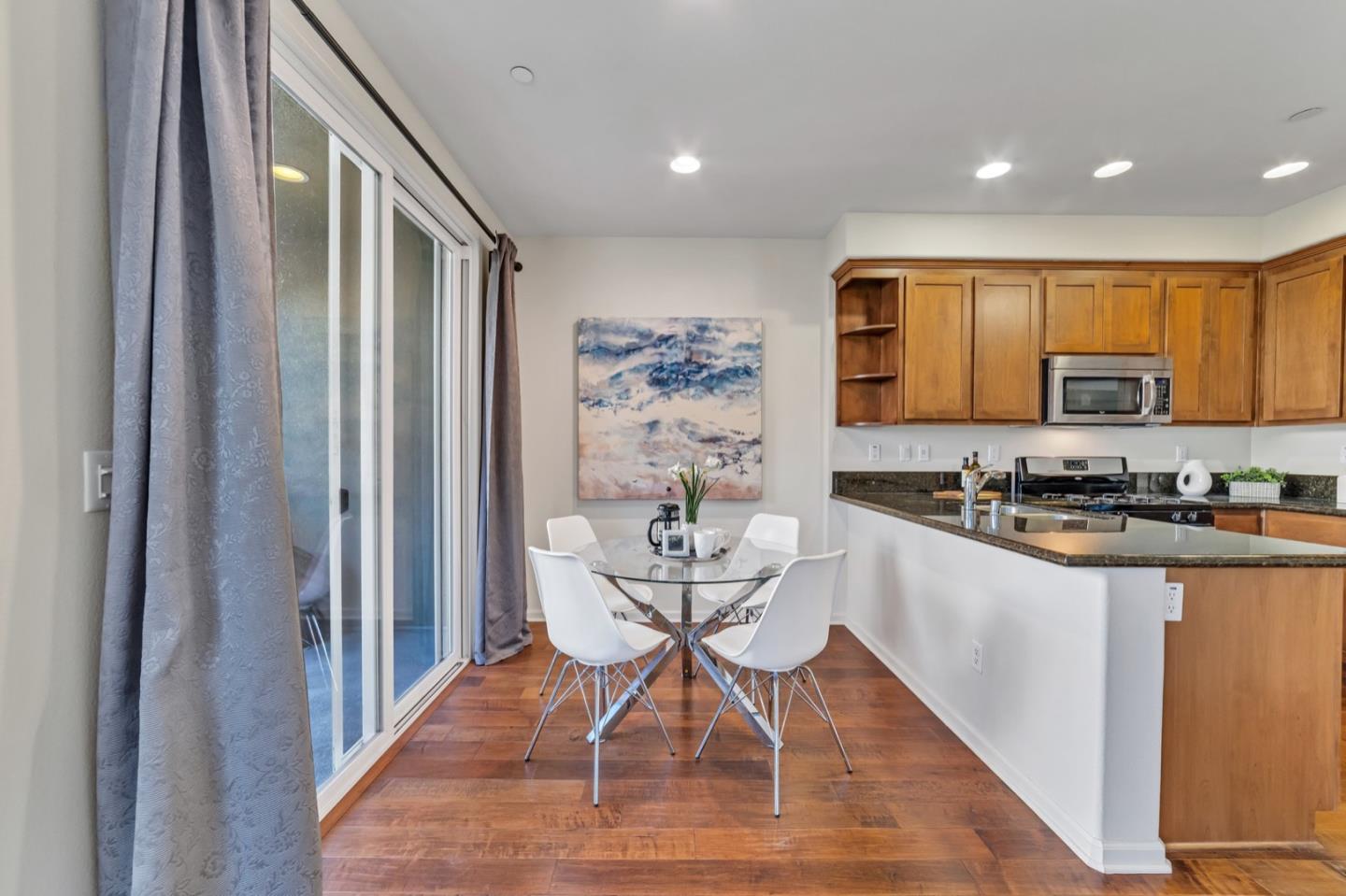 576 Almaden Walk Loop San Jose, CA 95125 - Photo 11 of 34 a kitchen with a table chairs a sink and dishwasher