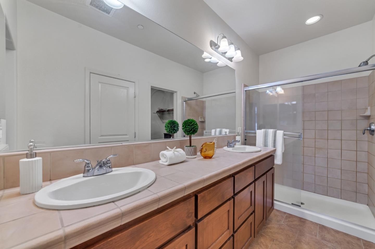 576 Almaden Walk Loop San Jose, CA 95125 - Photo 16 of 34 a bathroom with a sink a vanity a mirror and a shower