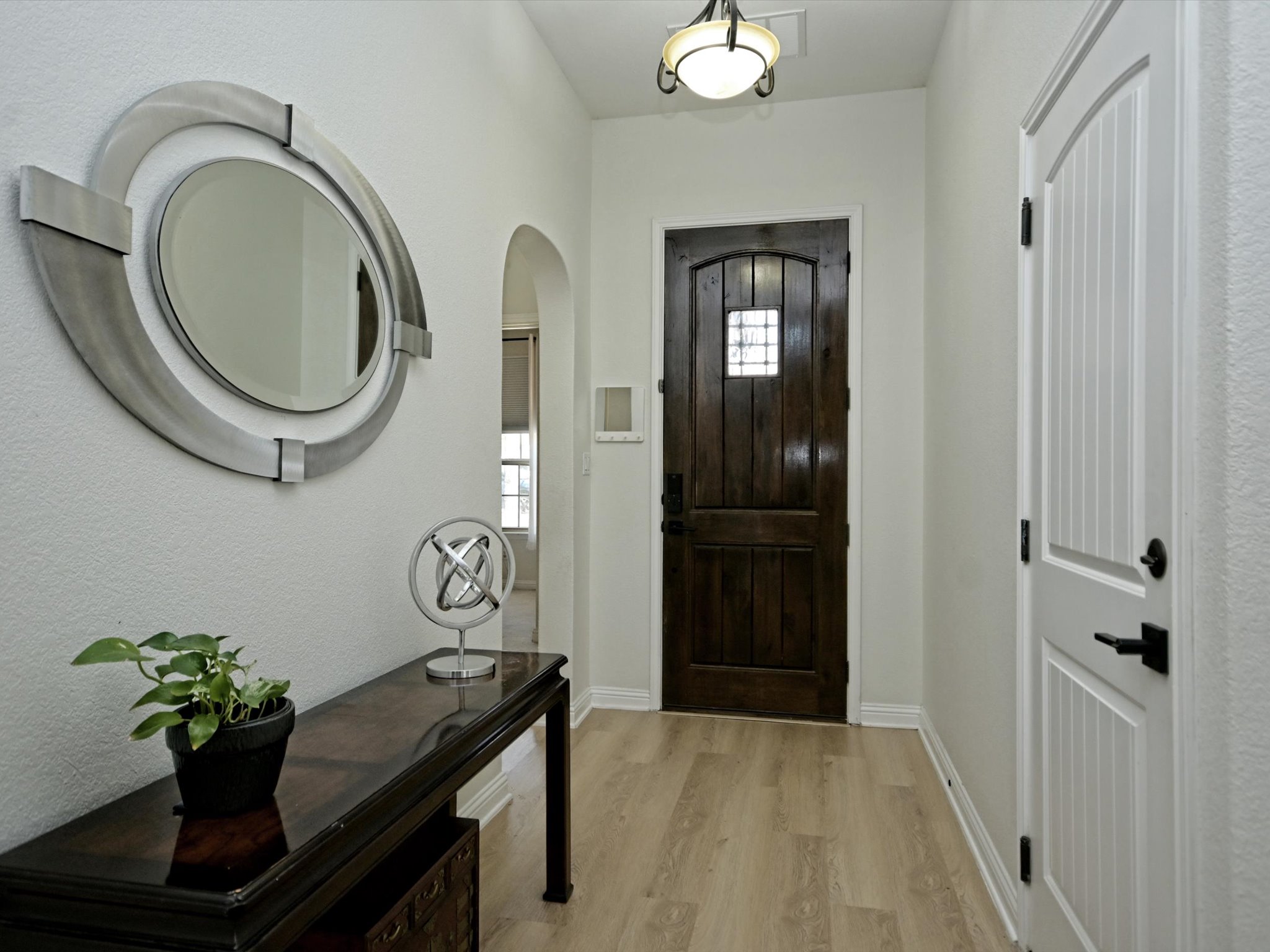 201 Bellagio Drive Austin, TX 78734 - Photo 18 of 31 Charming archways along the entry foyer open into the hallways to the main floor bedrooms.