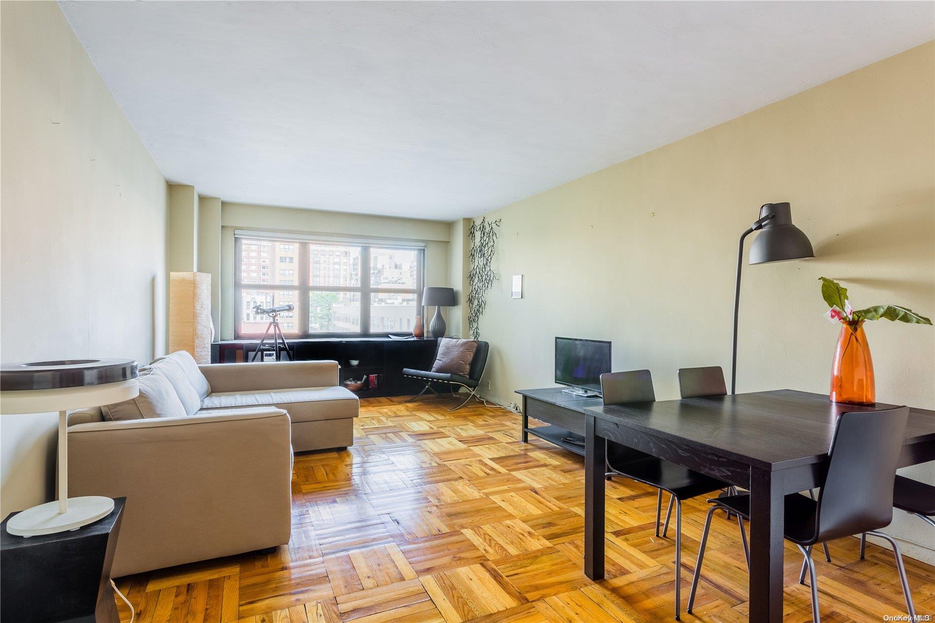 240 East 76th Street, Unit 7R Manhattan, NY 10021 - Photo 1 of 1 a living room with furniture and a window