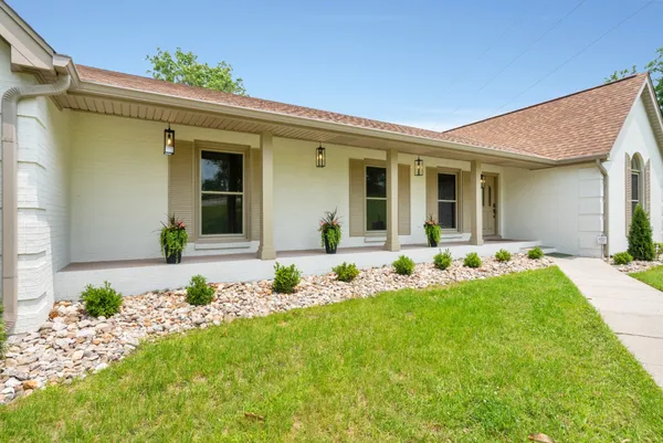 a view of balcony with wooden floor and seating space