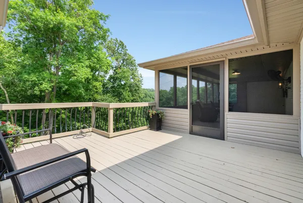a dining room with wooden floor a chandelier a wooden table and chairs