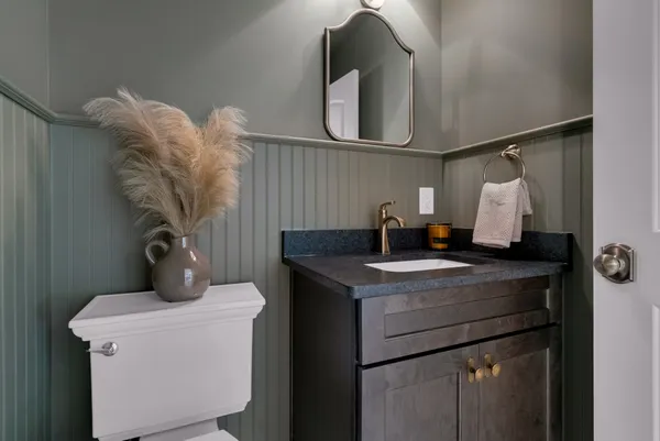 a living room with furniture and a ceiling fan