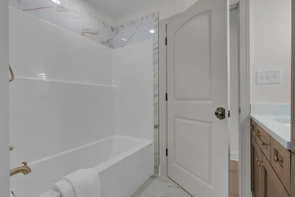 a view of empty room with a window and closet