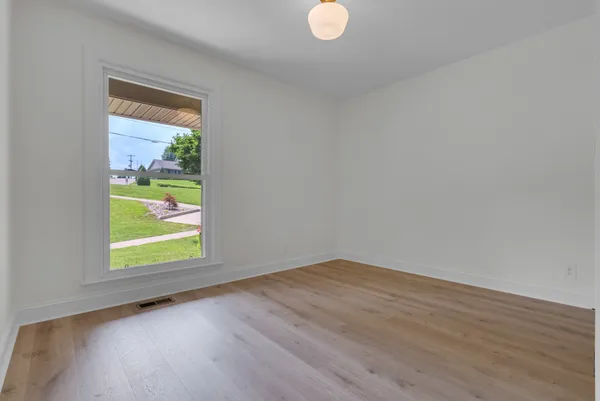 a view of a kitchen with wooden floor and stairs