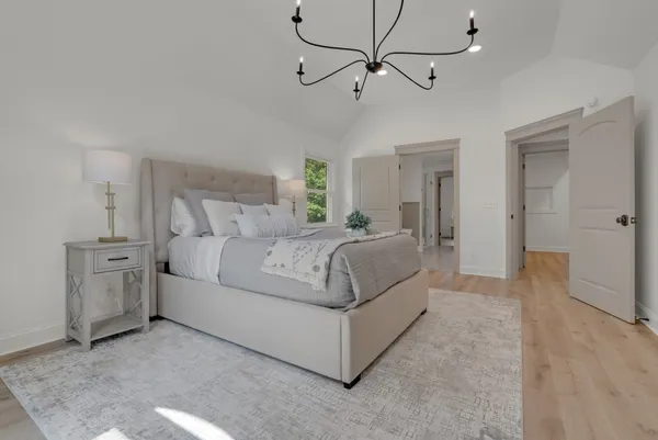 a view of empty room with wooden floor and fireplace
