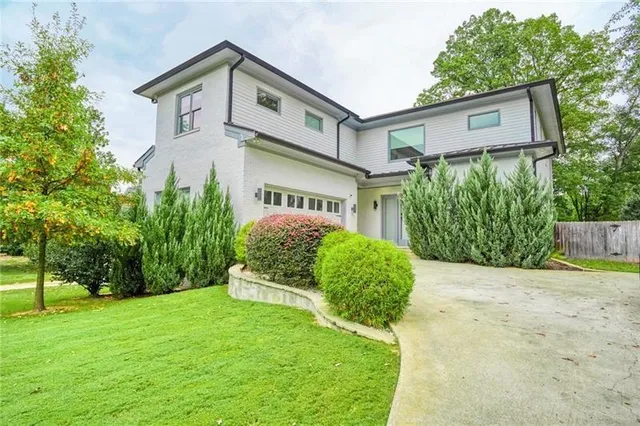 a front view of a house with garden