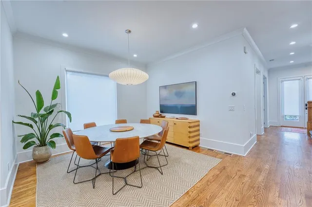 a view of a dining room with furniture and wooden floor