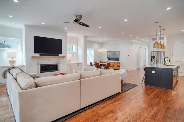 a living room with furniture a fireplace and a flat screen tv