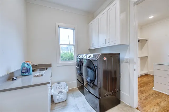 a utility room with fridge and washer