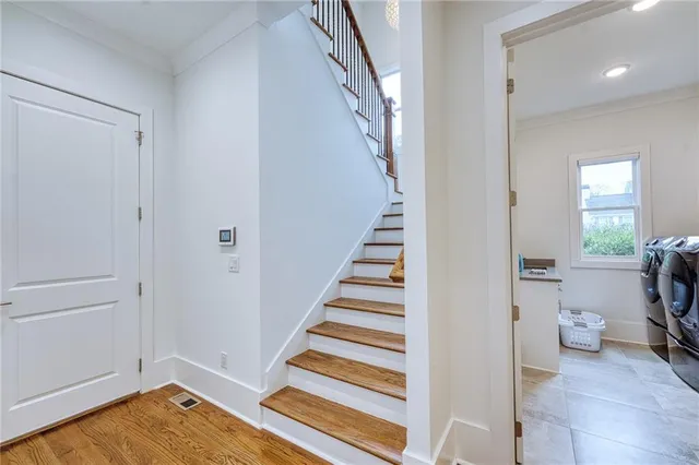 a view of a hallway with wooden floor and entryway