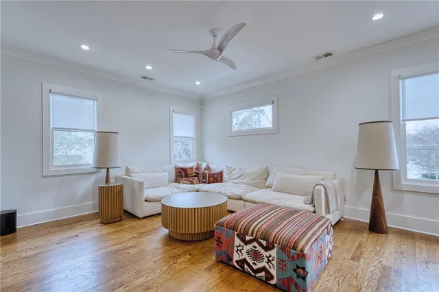 a living room with furniture and wooden floor