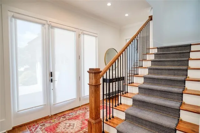 a view of entryway and hall with wooden floor
