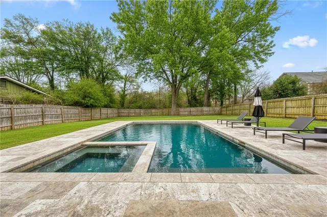 a view of swimming pool with a back yard