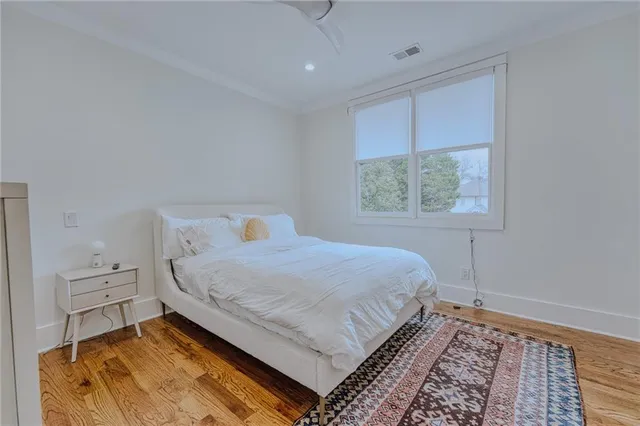 a bedroom with a large bed and a window