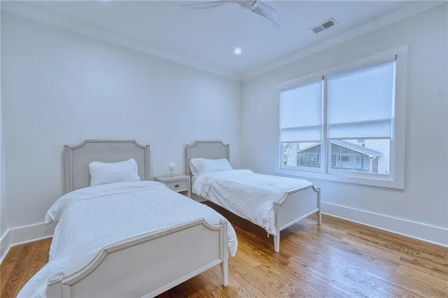 a bedroom with two beds and a window