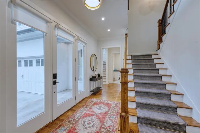 a view of entryway and hall with wooden floor