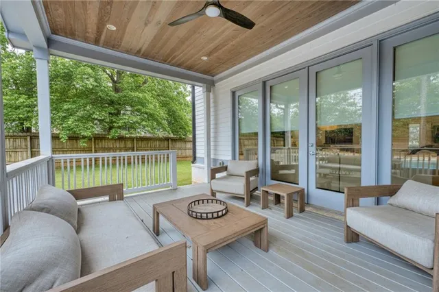 a living room with furniture and floor to ceiling windows
