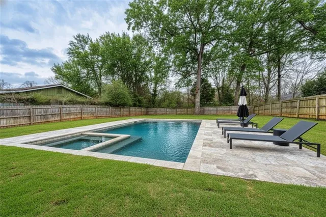 a view of swimming pool with sitting area and slide