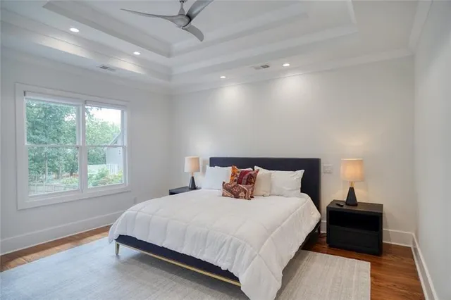 a bathroom with a granite countertop toilet sink and mirror