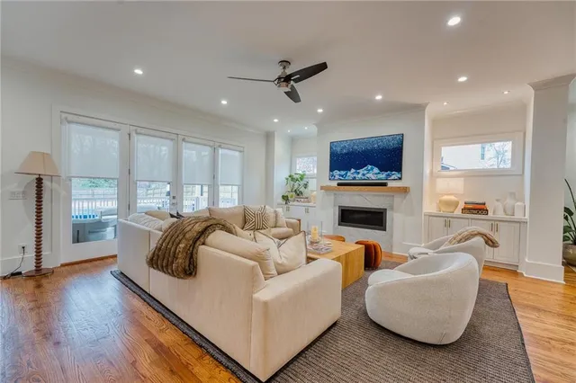 a living room with furniture a fireplace and a flat screen tv