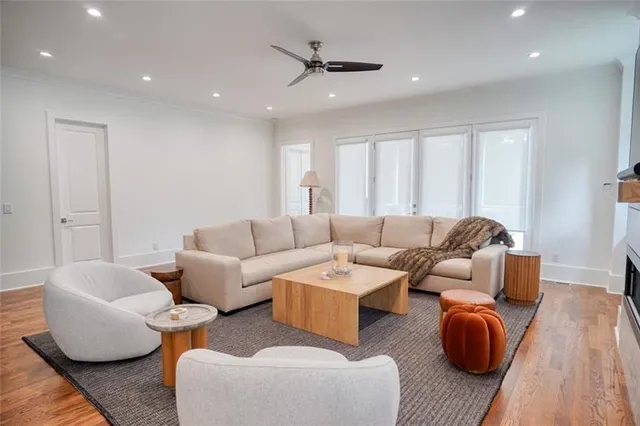 a kitchen with a sink a counter top space and living room view