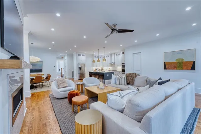 a living room with furniture kitchen view and a fireplace