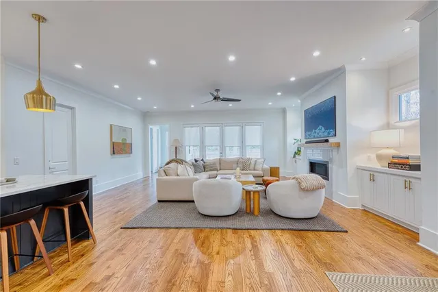 a living room with kitchen island furniture and a wooden floor