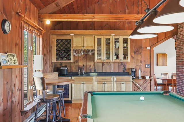 a bedroom with a bed wooden floor and window