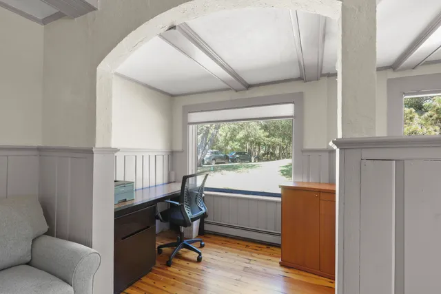 a view of a patio with table and chairs with wooden floor and fence