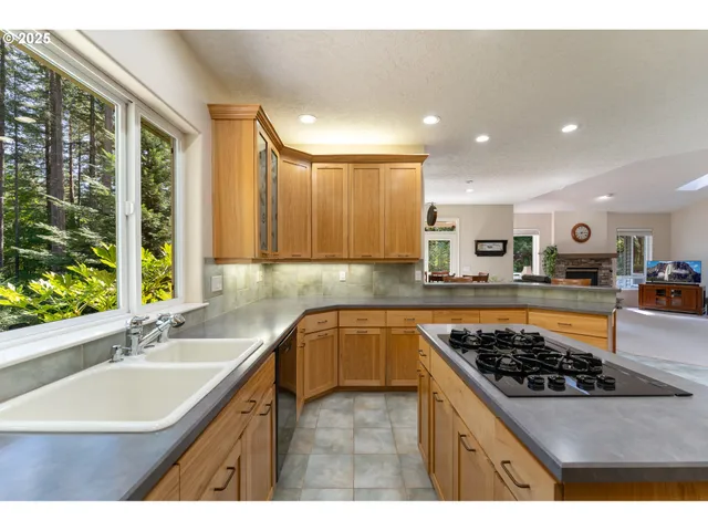 a kitchen with stainless steel appliances a sink stove and cabinets