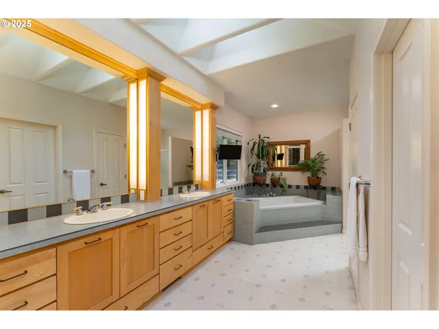 a large white kitchen with a large window